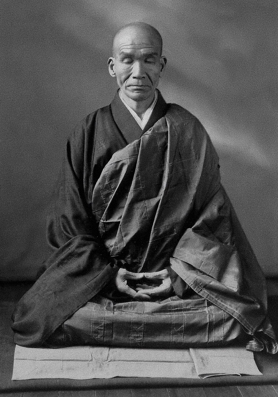 Kōdō Sawaki seated in zazen — full lotus posture, hands in the cosmic mudra